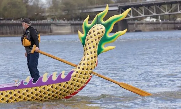 Tiller at tail end of Dragon Boat with Till in the water.